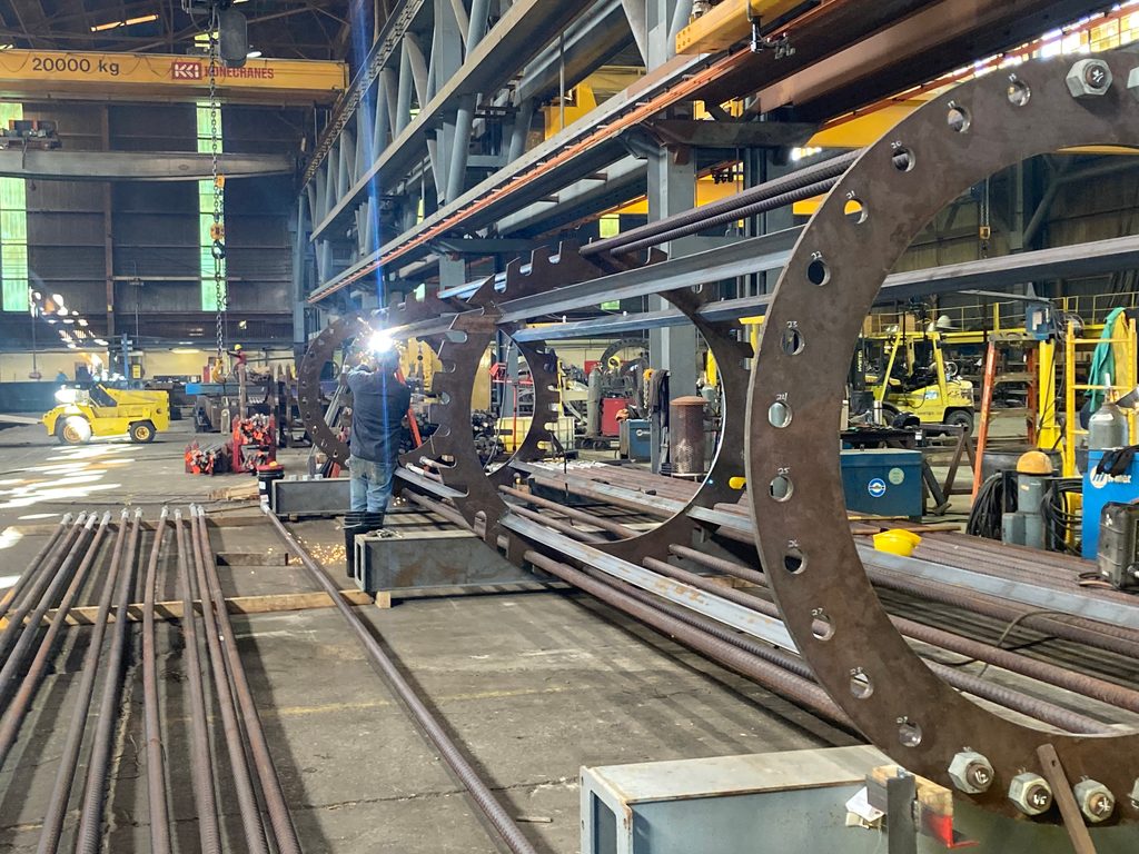 A 45-foot anchor bolt cage assembly laid out before shipment.